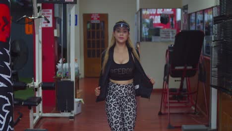 a latin girl in sports wear walking in a gym in the caribbean