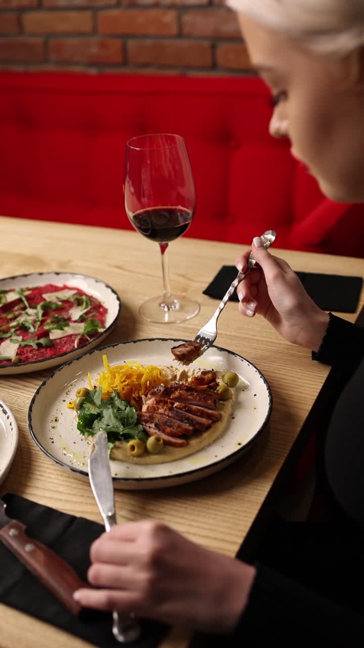 Woman Eating at Restaurant