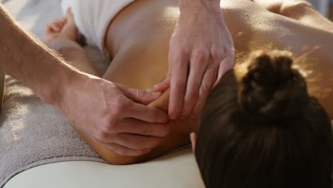 male physiotherapist giving back massage to female patient