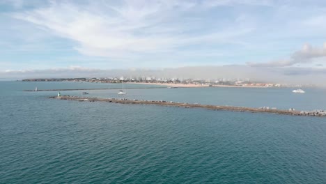 Rocky-Pier-with-Lighthouse-on-Porto-de-Portimao-Coast-in-Portugal,-Aerial