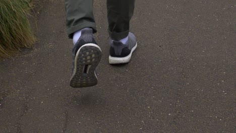 walking and striding with rolled-up trousers and cool trainers