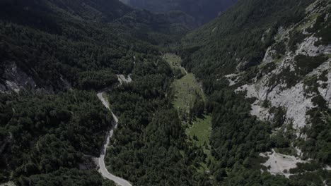 Drone-video-with-descriptive-frontal-shot-over-the-Vrsc-pass-in-Slovenia-with-mountains-on-the-horizon