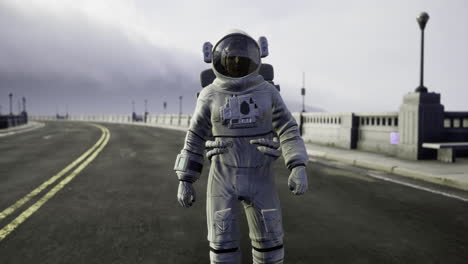 astronaut walks on an empty road under a cloudy sky at dusk