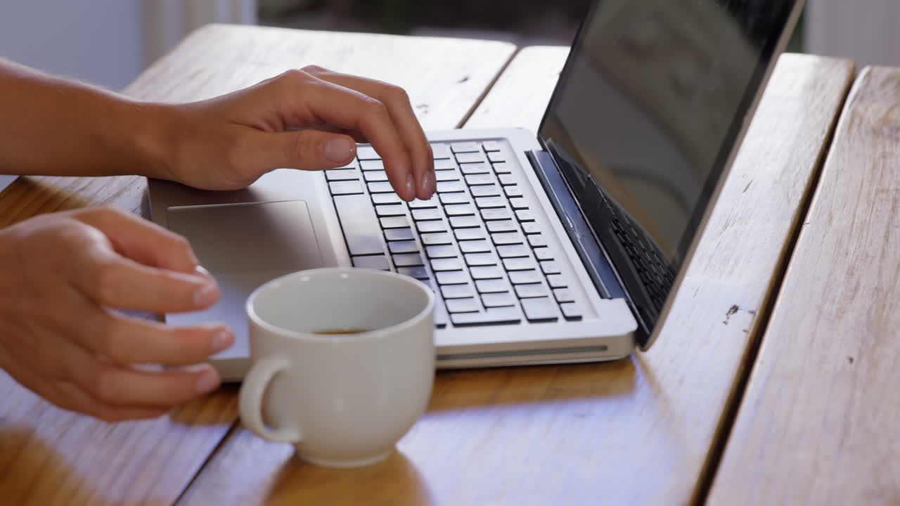 Cute blonde using laptop in kitchen