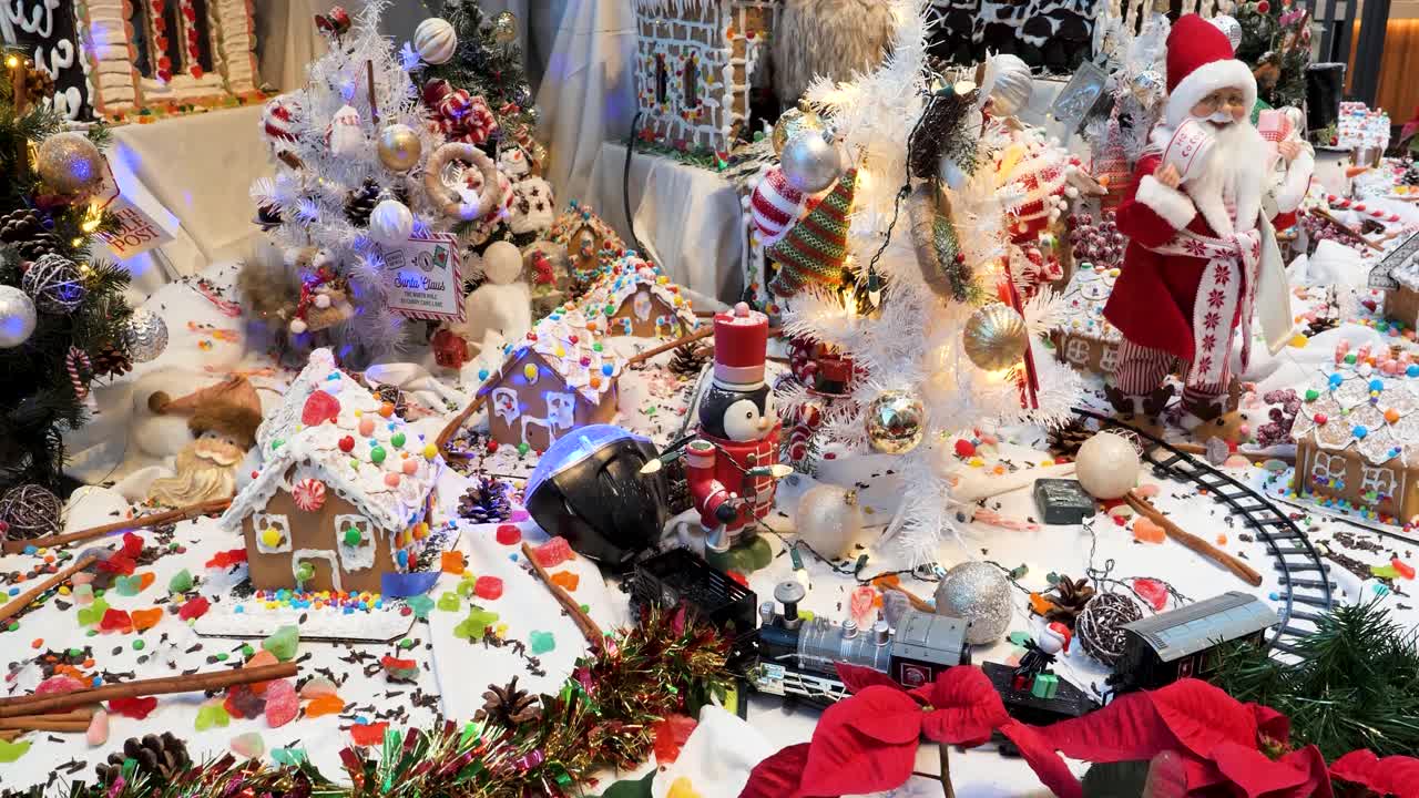 Christmas ornaments and decorations arrangement, Christmas traditions with Santa Claus, gingerbread houses, candies, toys, Christmas tree and Christmas lights.