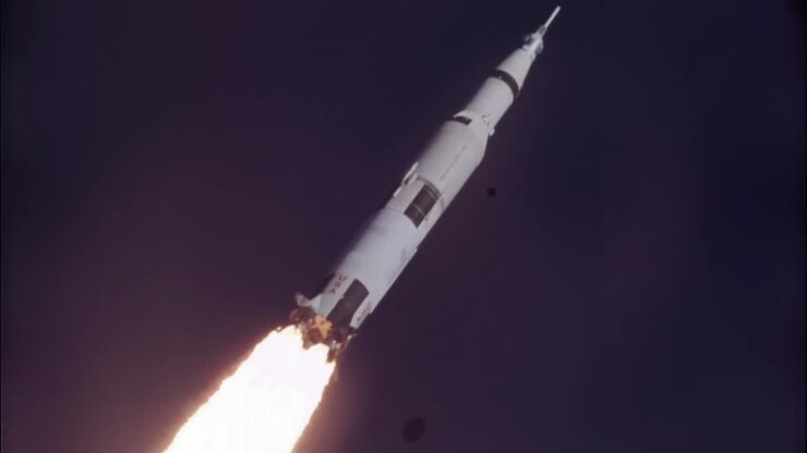 Saturn V rocket flying towards the moon.