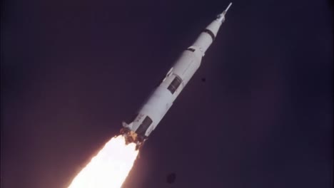 saturn v rocket flying towards the moon.
