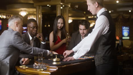 multiethnic group of people at the poker table in the casino.