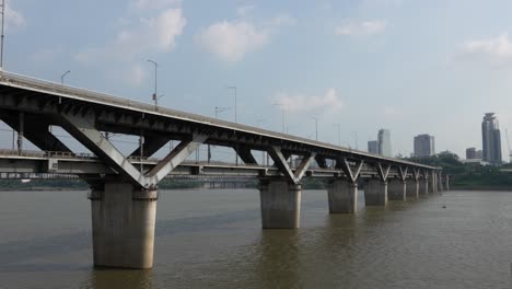 cheongdam bridge over river han and seoul metro train line 7 going to gangnam district, south korea