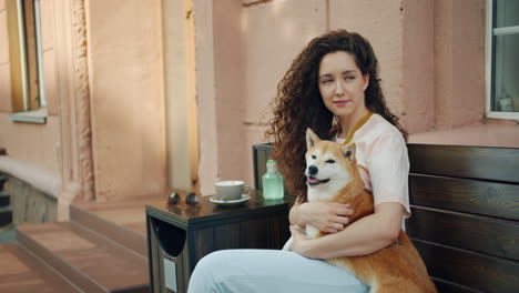 woman with her dog at a cafe