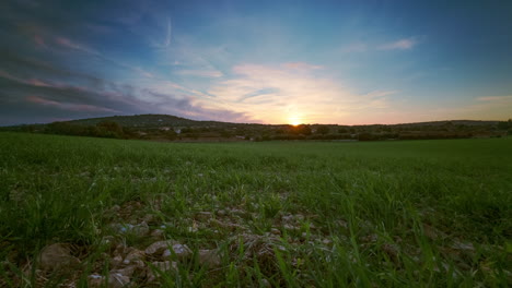 Stunning-timelapse-video-of-a-green-meadow,-gentle-hill,-and-floating-clouds-in-a-blue-sky