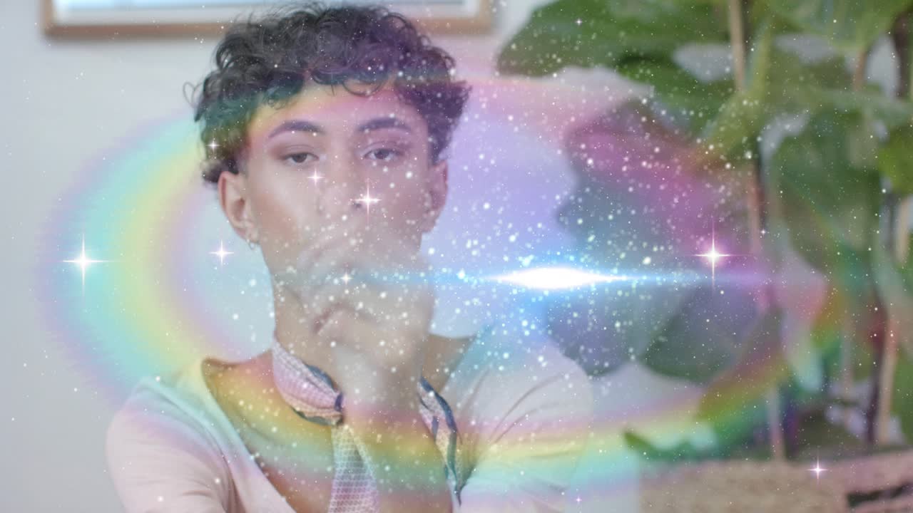 Male model sitting, at one-second haze drifting across subject, rainbow arcs forming for fashion