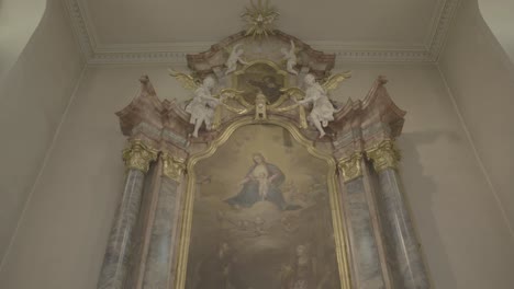 magnificent baroque altar with sculptures, columns, cross and tabernacle