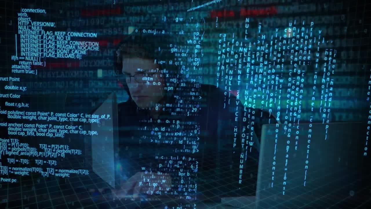 Hacker using computer in dark room