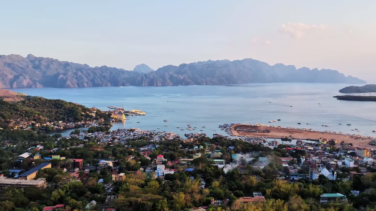 Coron city with the Coron island cliffs and the sea during sunset in the Philippines