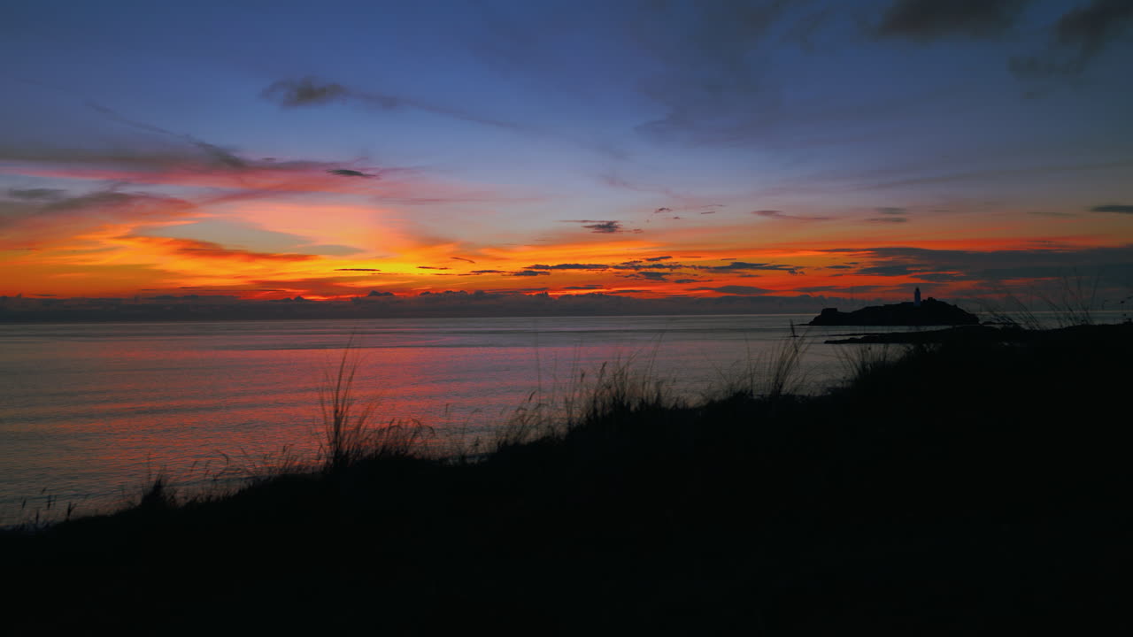 Cinemagraph seamless video loop of a sunset evening seaside beach close to St Ives in Cornwall, England, UK
