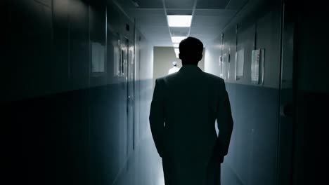 a doctor walks down a hospital hallway