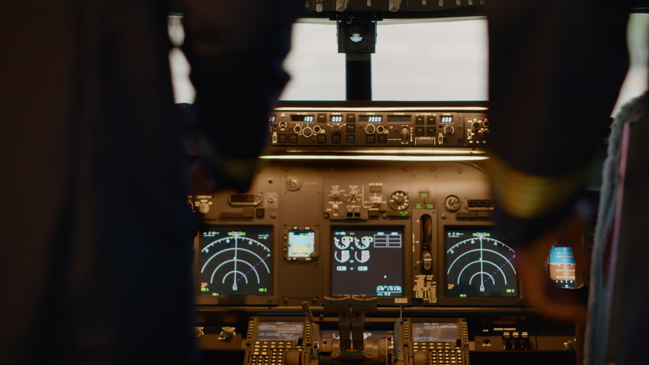 Diverse team of captain and copilot in cockpit flying airplane