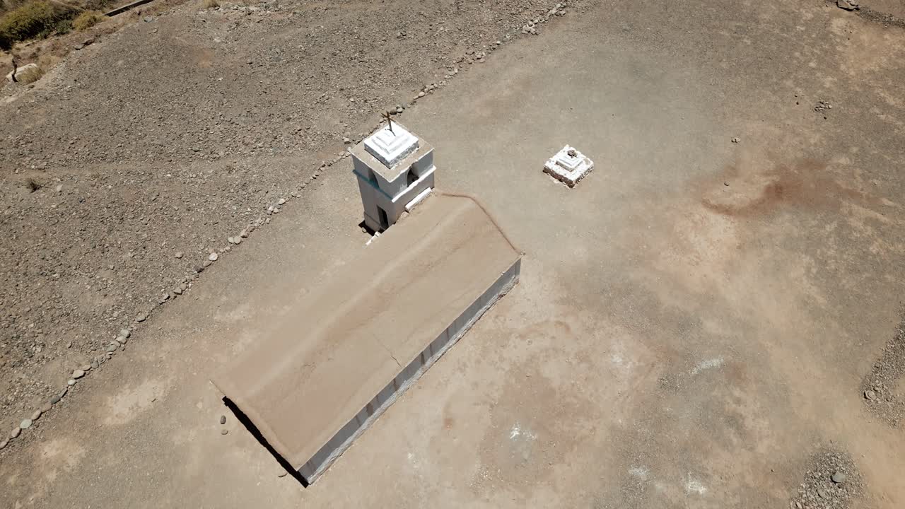 Witness the stunning beauty of Atacama's hidden oasis as a small church nestled in a valley is captured in breathtaking drone footage, showcasing its serene splendor from above