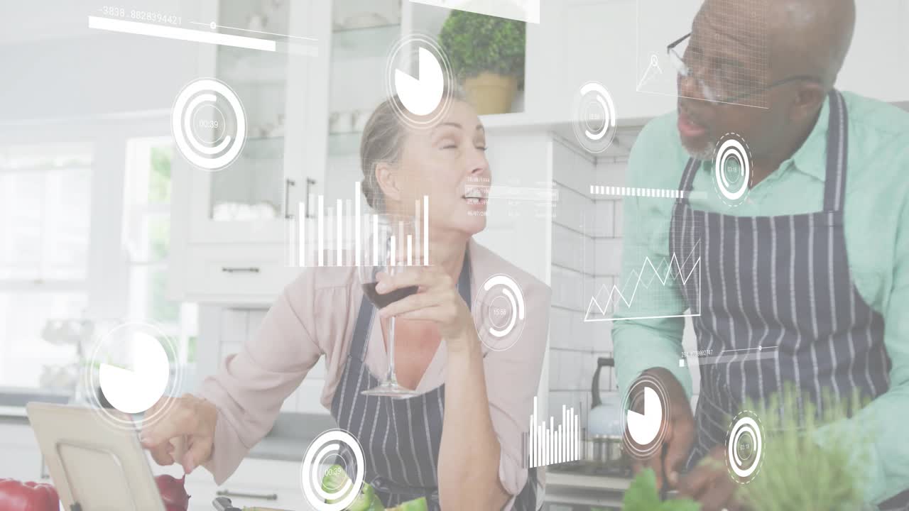 Woman tapping tablet initiating floating graphs while man chopping herbs into salad for health