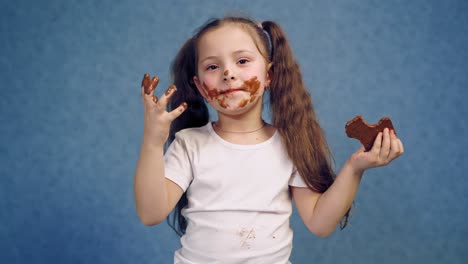 girl with chocolate plate. little girl eating chocolate plate on table
