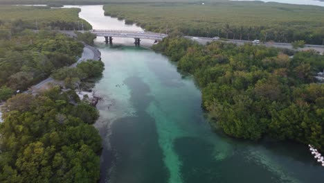 Aerial-shot-of-people-driving-towards-their-resorts-over-the-Punta-Nizuc-bridge