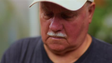 Close-up-of-Face-of-Older-Man-Preparing-Apple-Juice-in-Garden-During-late-Summer