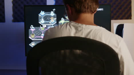 boy laying down his ps5 controller and headset then walking away after gaming on his playstation 5 in an rgb led room at night, close