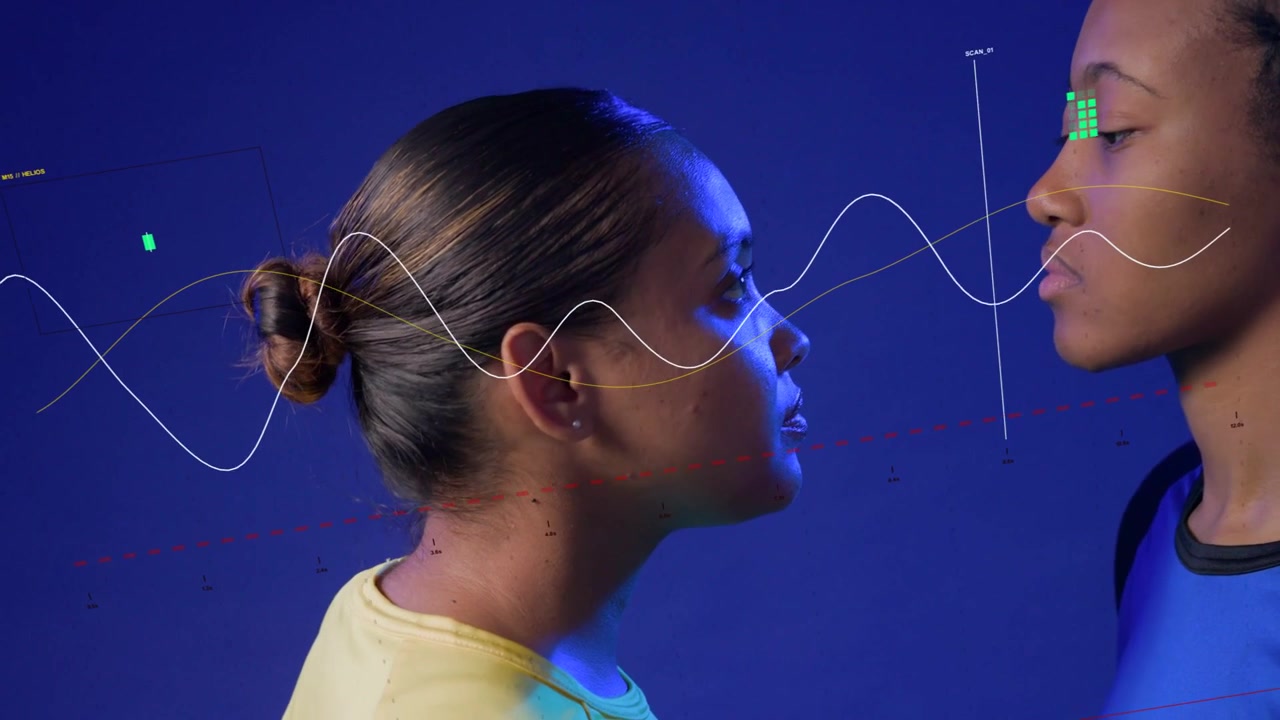 Two women entering blue backdrop, second moving in initiating waveform linking faces for tech demo
