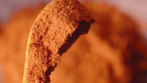 orange spice powder on a spoon