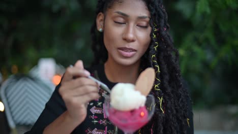 mujer afro latina comiendo helado en un restaurante