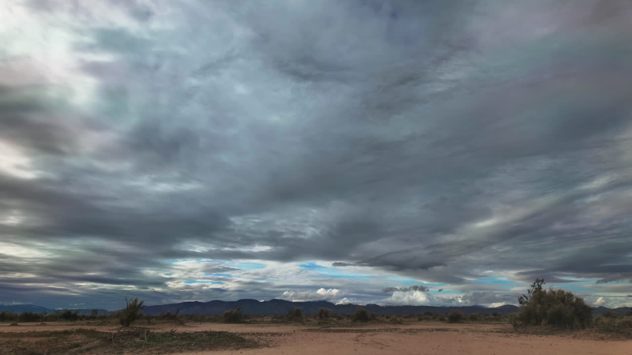 vista expansiva del desierto de mojave con formaciones de nubes dinámicas, lapso de tiempo
