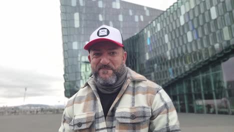 man making jokes at the harpa in reykjav&iacute;k outside