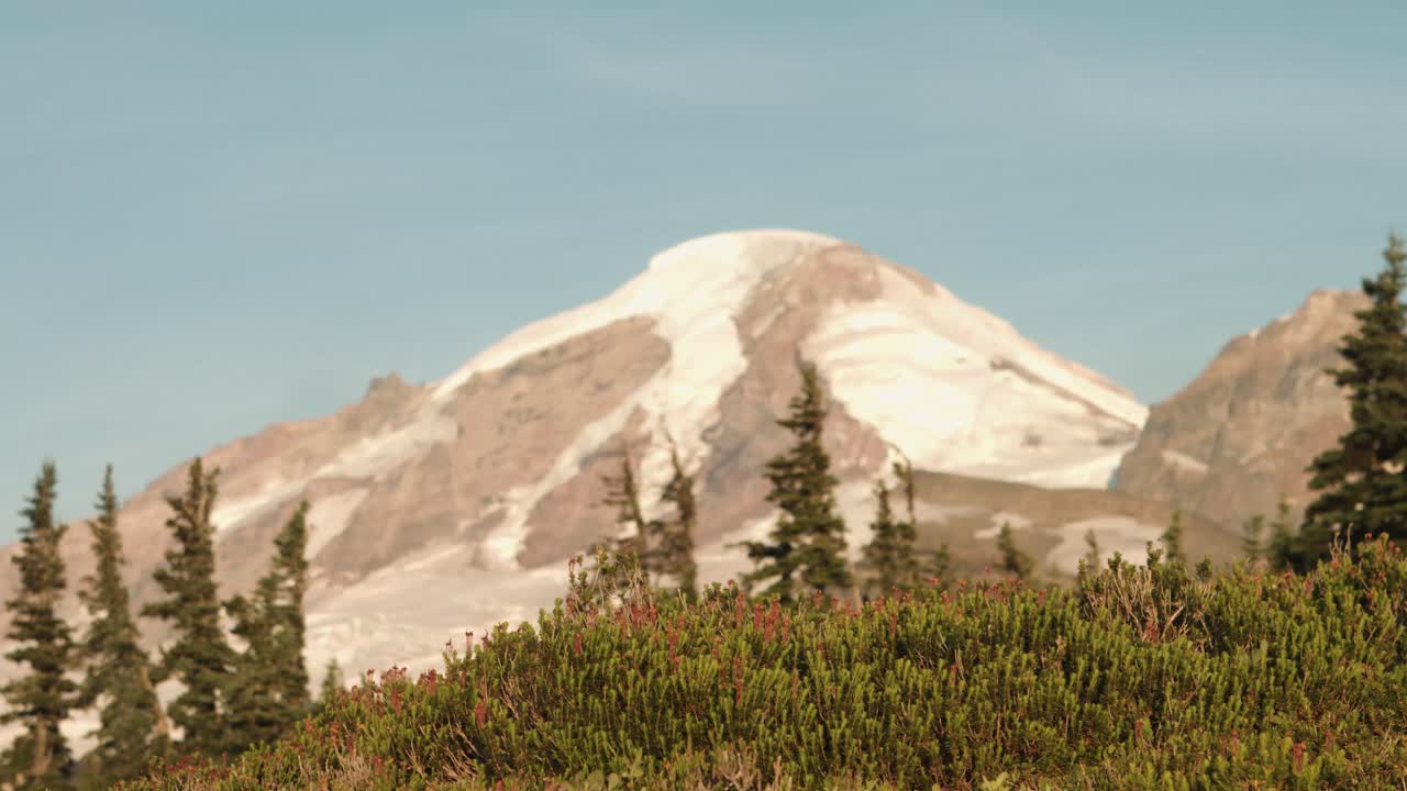 Sunlight strikes a snow-capped mountain
