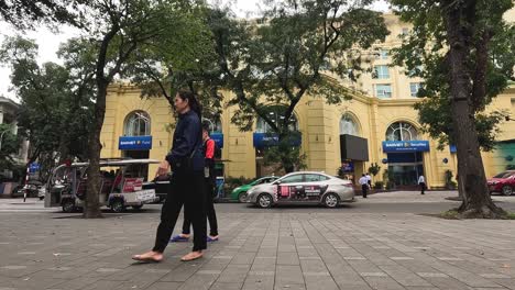 pedestrians walking across a busy urban square