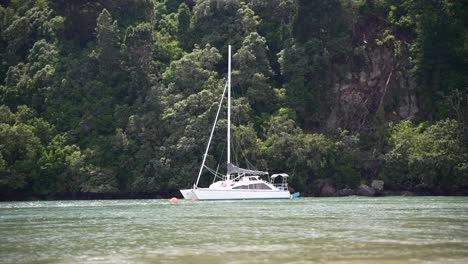 yacht floating along river at high tide