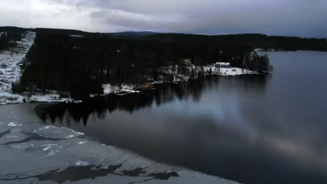 winter wonderland: serene lake and cabin in snowy forest