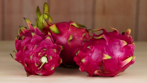 dragon fruits arranged on a wooden table