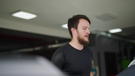 bearded caucasian male run on indoor gym treadmill, endurance training