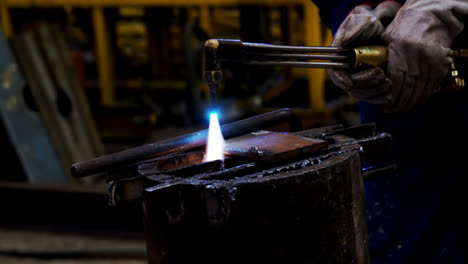 male engineer using velding torch in workshop 4k