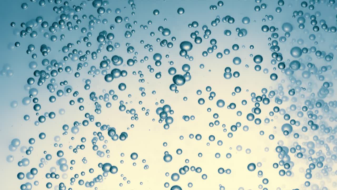 Many water bubbles in blue water close up, abstract water wave with bubbles in slow motion.