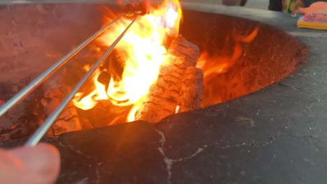 cooking food at a large bonfire