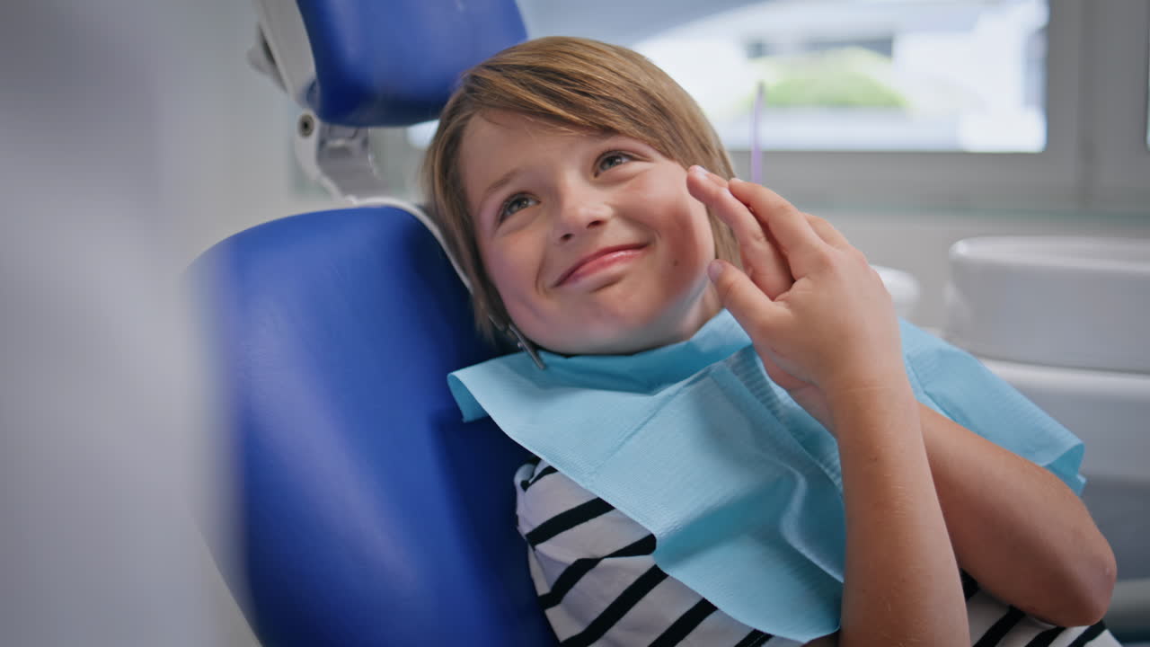 Kid sitting dentistry appointment in pediatric clinic closeup. Little patient