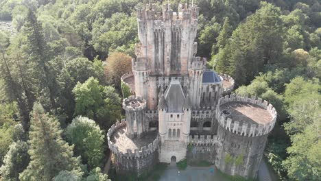 Enchanted-aerial-view-of-medieval-Butron-Castle-in-Gatika,-Spain,-lowering