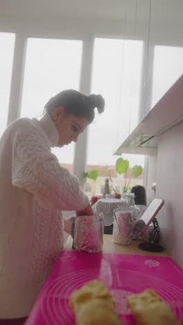 woman baking bread or pastries in kitchen