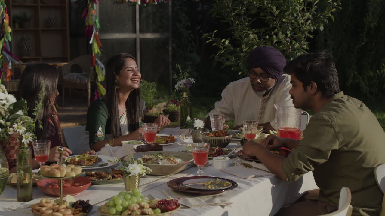 Festive Outdoor Dining with Family and Friends Enjoying a Meal