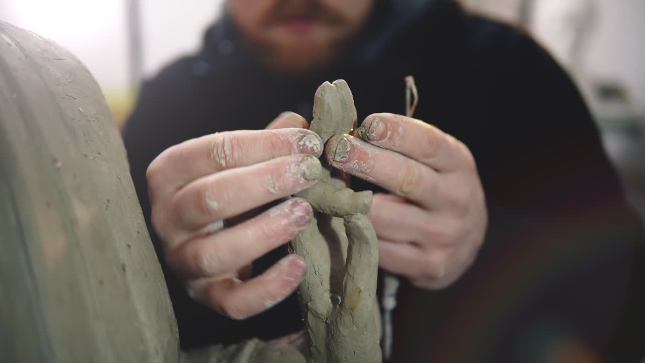 Cropped view of clay Buddha's statue hand, artist modeling hands using hands