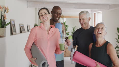 portrait of happy diverse seniors and female pilates coach with drinks, unaltered, in slow motion