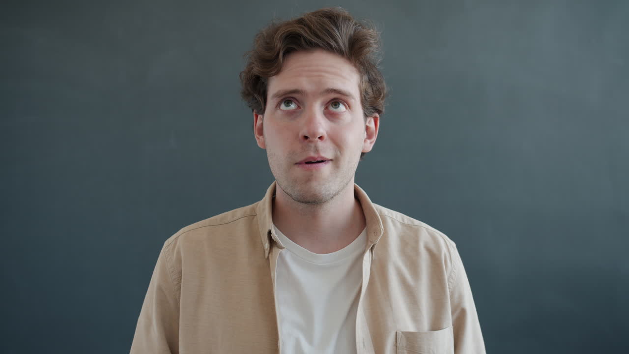 Man looking upward, thoughtful expression