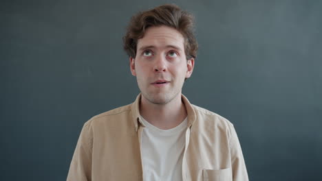 man looking upward, thoughtful expression